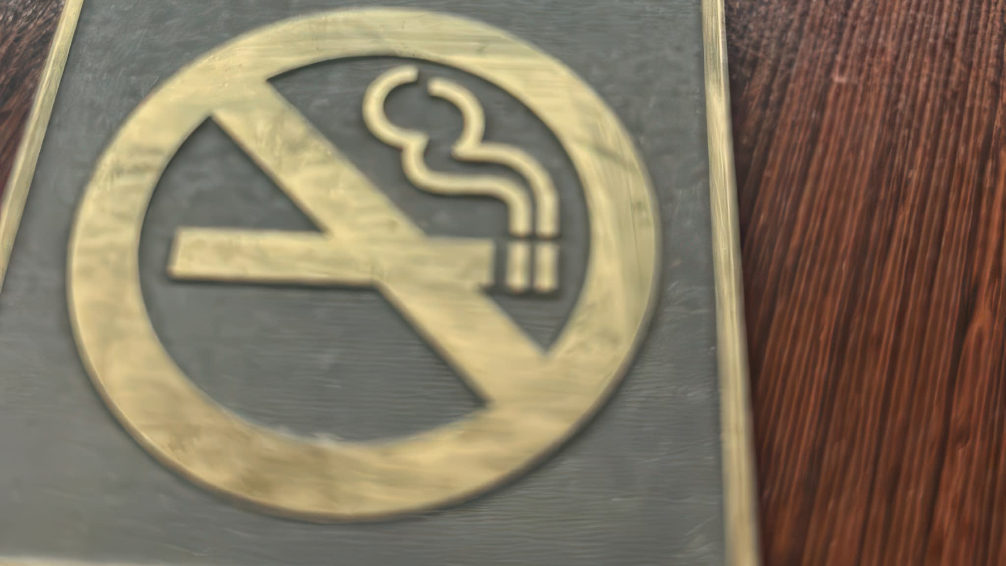 Гравирана метална табела със знак Забранено пушенето – златисто лого върху тъмен фон.