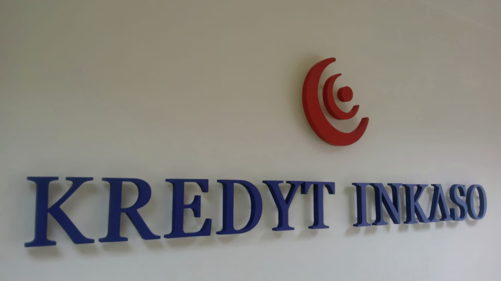 Обемни букви 'KREDYT INKASO' в син цвят с червено лого, монтирани на стена – пример за корпоративна вътрешна реклама.