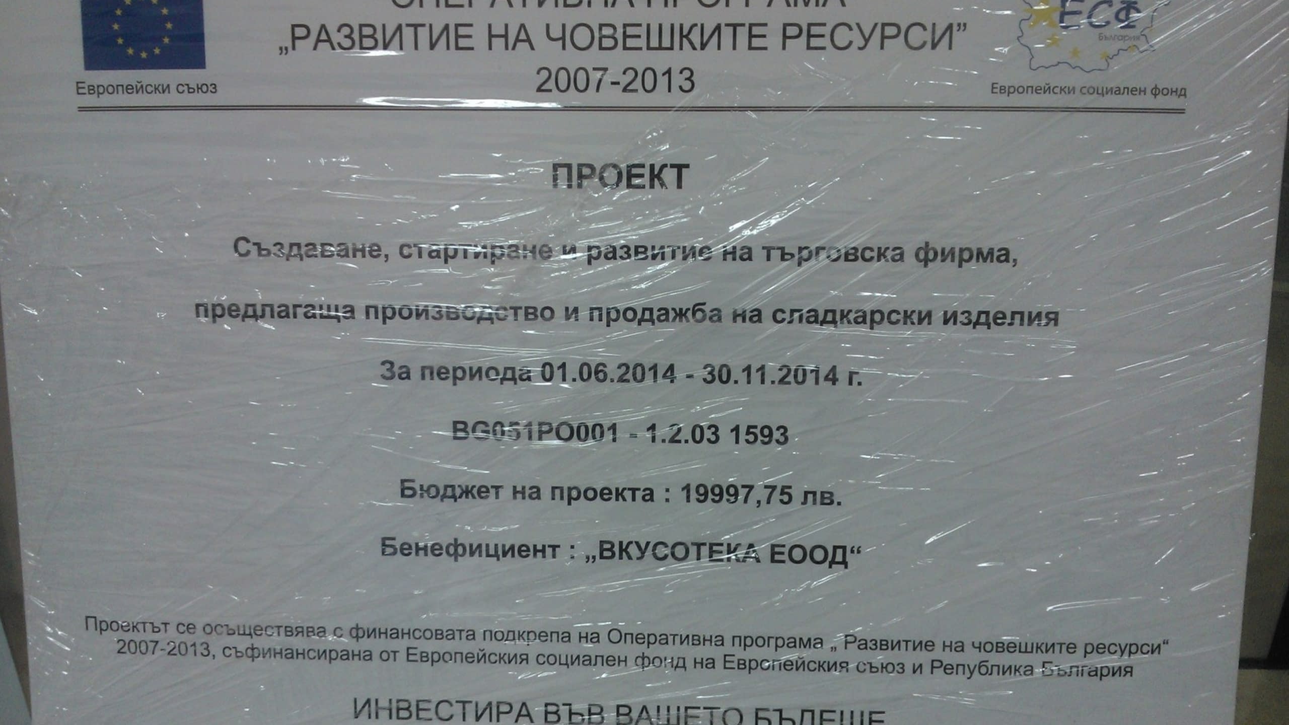 Информационна табела за проект по Оперативна програма "Развитие на човешките ресурси", опакована в прозрачно фолио.